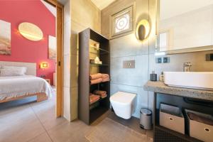 a bathroom with a sink and a toilet and a bed at Casita Max in Costa Teguise +33 photos