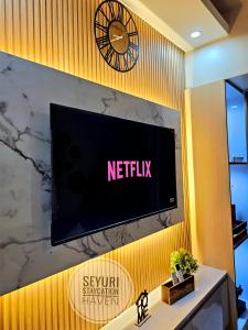 a television on a wall in a room at Seyuri Staycation Haven in Manila