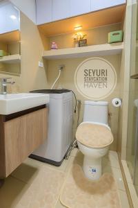 a bathroom with a toilet and a sink at Seyuri Staycation Haven in Manila