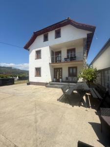 a large white building with a patio in front of it at Pensiunea Diana in Novaci
