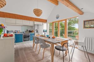 a kitchen with a dining room table and chairs at House 27 in Looe