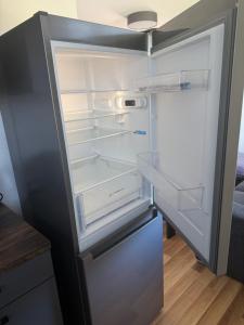 an empty refrigerator with its door open in a kitchen at Niinepesa in Haapsalu