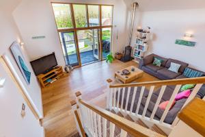 a living room with a couch and a tv at House 27 in Looe
