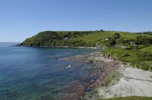 an island in the ocean next to a body of water at House 27 in Looe