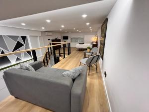 a living room with a gray couch and a table at Apartamento Castillejos 4 in Tarifa