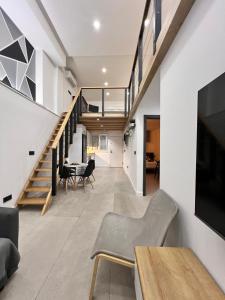 an open living room with a staircase and a dining room at Apartamento Castillejos 4 in Tarifa