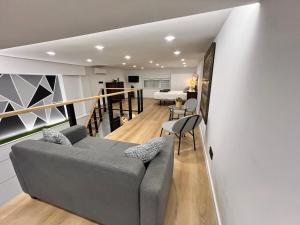 a living room with a couch and a bedroom at Apartamento Castillejos 4 in Tarifa +14 photos