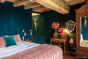 a bedroom with a bed and a table with a mirror at Country Villa With Indoor Pool In Beaujolais in Romanèche-Thorins +32 photos