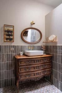 a bathroom with a sink and a mirror at Country Villa With Indoor Pool In Beaujolais in Romanèche-Thorins
