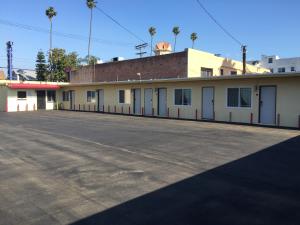 een lege parkeerplaats voor een gebouw bij Park Motel in Los Angeles +6 foto's