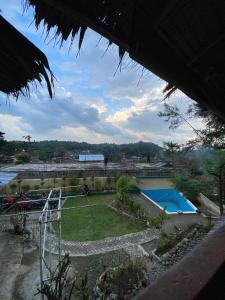 a view of a yard with a tennis court at Bukitlawangtour and Accomodation in Bukit Lawang