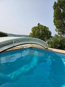 a swimming pool with a bridge over it at La Maison de Marie in Puimoisson