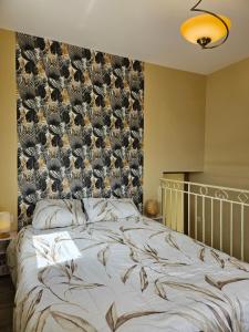 a bedroom with a large bed with a bird wallpaper at La Maison de Marie in Puimoisson +7 photos