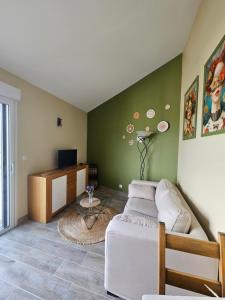 a living room with a couch and a table at La Maison de Marie in Puimoisson