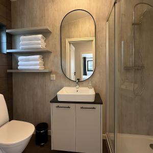 a bathroom with a sink and a mirror at Lake cottage with excellent view in Akranes