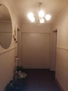 a hallway with a white garage door and a chandelier at Radiant Residence in Grahamstown +87 photos