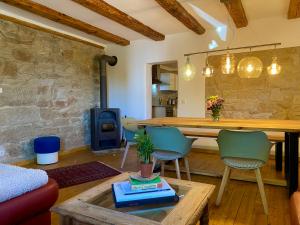 a living room with a table and chairs and a fireplace at Kap der guten Hopfung in Absberg