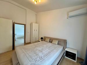 a bedroom with a large white bed in it at Kumbor summer holiday in Topla