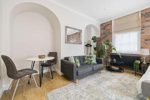 a living room with a couch and a table at City Centre Entire Studio Apartment- Self check in in Chichester