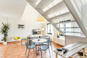 a living room with a table and chairs and a couch at Begur Sunset 2 bedroom loft close to the center of Begur. With terrace and gorgeous sea views H42 in Begur