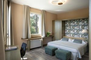 Voodi või voodid majutusasutuse Grand Hotel Panoramic toas