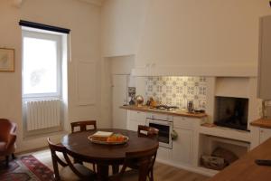 a kitchen with a table and a dining room at Il Gelsomino in Capranica