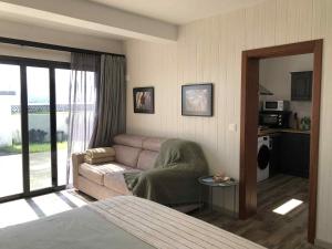 a living room with a couch and a bed at Seacrets Beach House in Praia do Almoxarife
