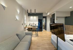 a living room with a couch and a kitchen at TWO ENTIRE APARTMENTS LIV Luxury Central C-D in Thessaloniki