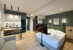 a bedroom with a large bed and a kitchen at TWO ENTIRE APARTMENTS LIV Luxury Central C-D in Thessaloniki