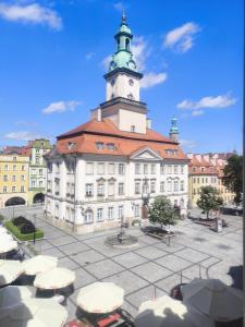 a large building with a clock tower on top of it at Neo Retro in Jelenia Góra