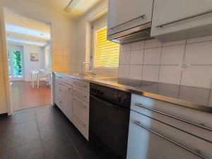 a kitchen with a sink and a dishwasher at Charmantes Studio in Teufen in Teufen