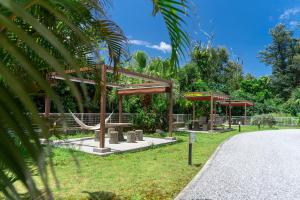 a park with a hammock in the grass at Odysis Onna Resort Hotel in Onna +49 photos