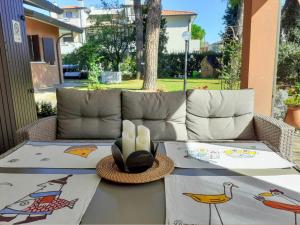 a table on a patio with a couch at Villa Bruna in Cesenatico +23 photos