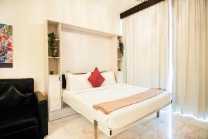 a bedroom with a bed and a chair and a window at Luxury Studio Bayz By Danube Business Bay Marasi Drive Dubai in Dubai +25 photos