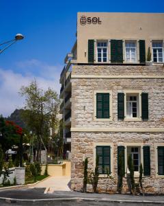 a building with a sign on the side of it at Sol Hotel Haifa in Haifa