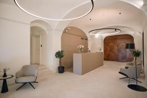 a lobby with two chairs and a reception desk at Heritage Hotel Kurija Mihalović in FeriÄanci +134 photos