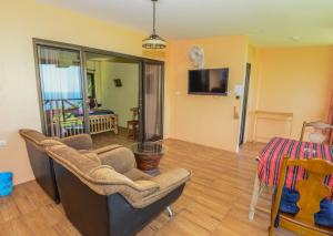 a living room with a couch and a table at Sairee View Resort in Ko Tao