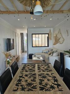 a living room with a table and a couch at La Cabane vue mer et port in Cap d'Agde