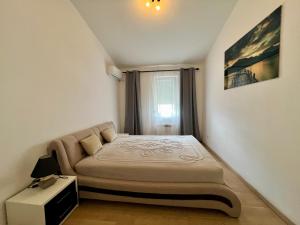 a small bedroom with a bed and a window at Kumbor summer holiday in Topla