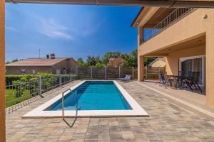 a swimming pool in the backyard of a house at Villa NOOK in Risika