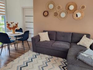 a living room with a couch and a table with chairs at Jūras māja in Klapkalnciems