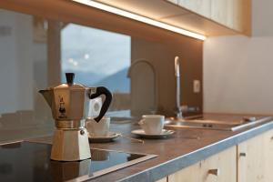 a coffee pot sitting on a counter in a kitchen at Prielerhof in Chienes
