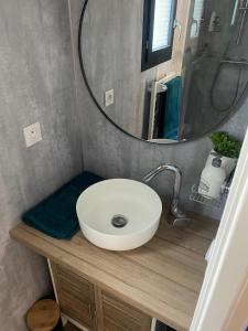 a bathroom with a sink and a round mirror at Bonamy's in Saint-Ouen +23 photos
