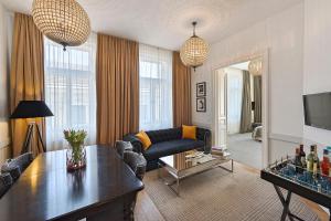 a living room with a couch and a table at 6 rooms Naschmarkt in Vienna