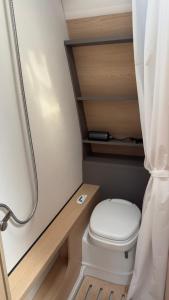 a small bathroom with a toilet and a shower at On Wheels by Yerra in Yervandashat