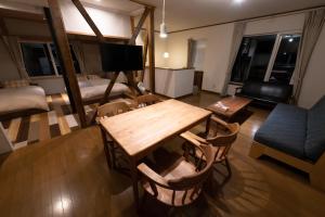 a room with a table and chairs and a bedroom at ふらのの丘 in Kami-furano +18 photos