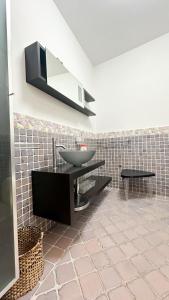 a bathroom with a sink and a mirror on the wall at Le camere di Vicoli e Mare in Maratea +8 photos