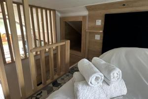 a bedroom with a bed with towels on it at Self-Catering Lodge with Hot Tub in Inverness