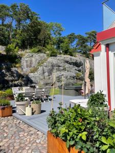a patio with chairs and plants in front of a building at Villa Lysholmen in Särö