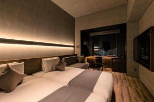 a hotel room with two beds and a window at The Royal Park Hotel Iconic Tokyo Shiodome in Tokyo